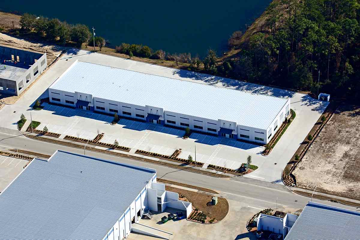 Aerial of a single-story, long bay metal building system with 45-ft bays in the rear at Port Jax Trade Center in Florida. Aerial of a single-story, long bay metal building system with 45-ft bays in the rear at Port Jax Trade Center in Florida.