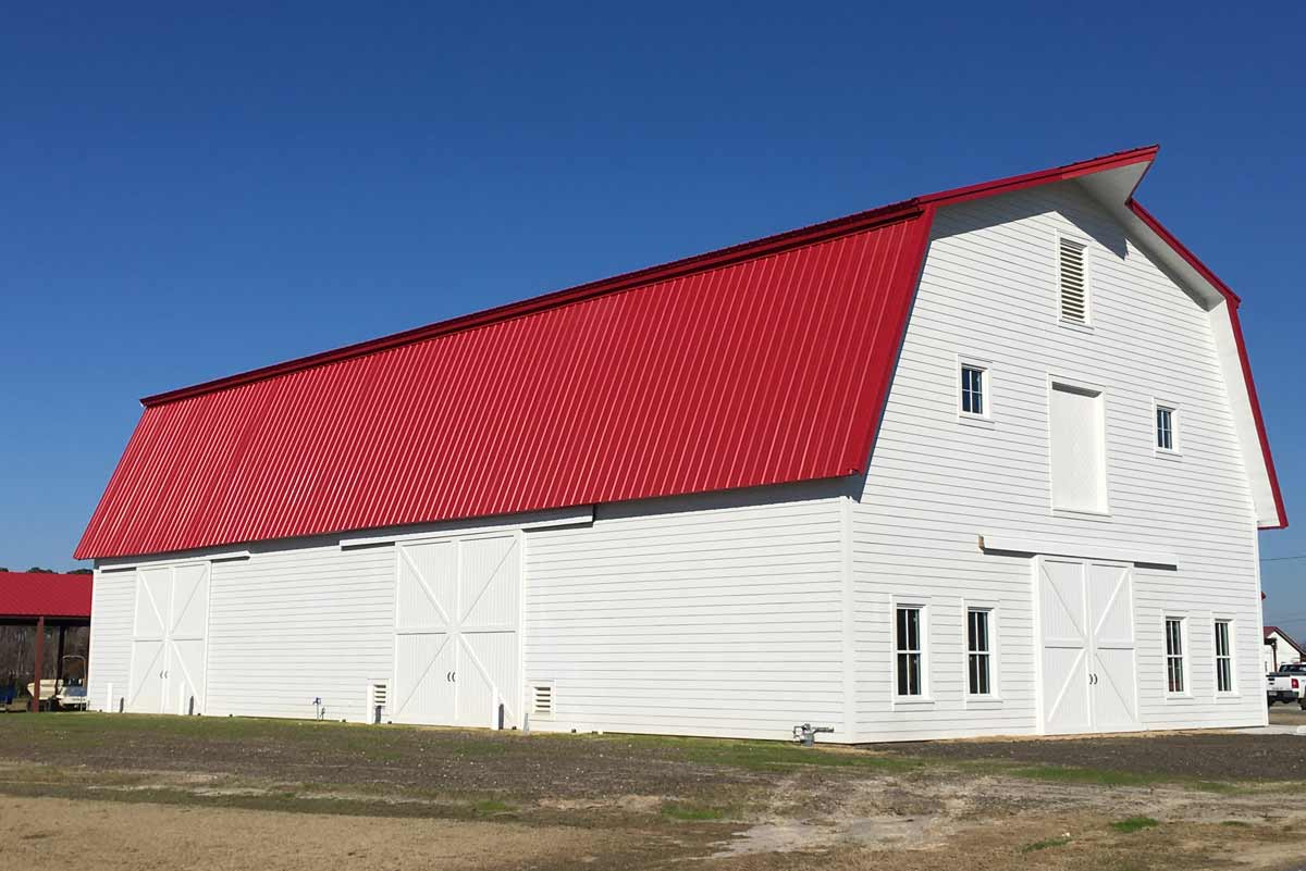 This 5100 square foot gabrel style metal barn is 42 feet high at its peak and topped with 24-gauge PBR Kynar roof coated in bright red. 