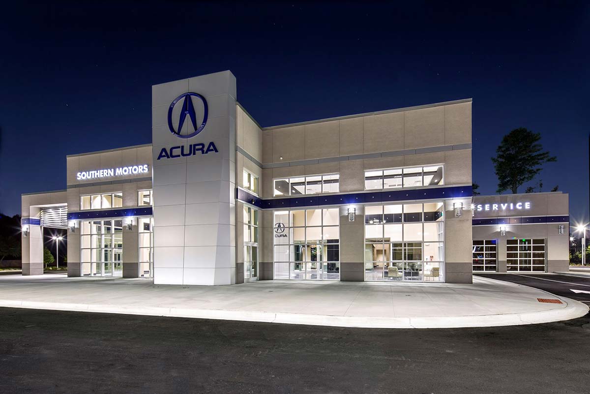 Southern Motors Acura dealership in Georgia at night with light emanating from showroom windows of a metal building system. Southern Motors Acura dealership in Georgia at night with light emanating from showroom windows of a metal building system.